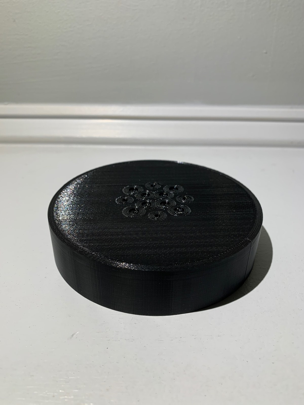 The printed base cap showing its bolt circle