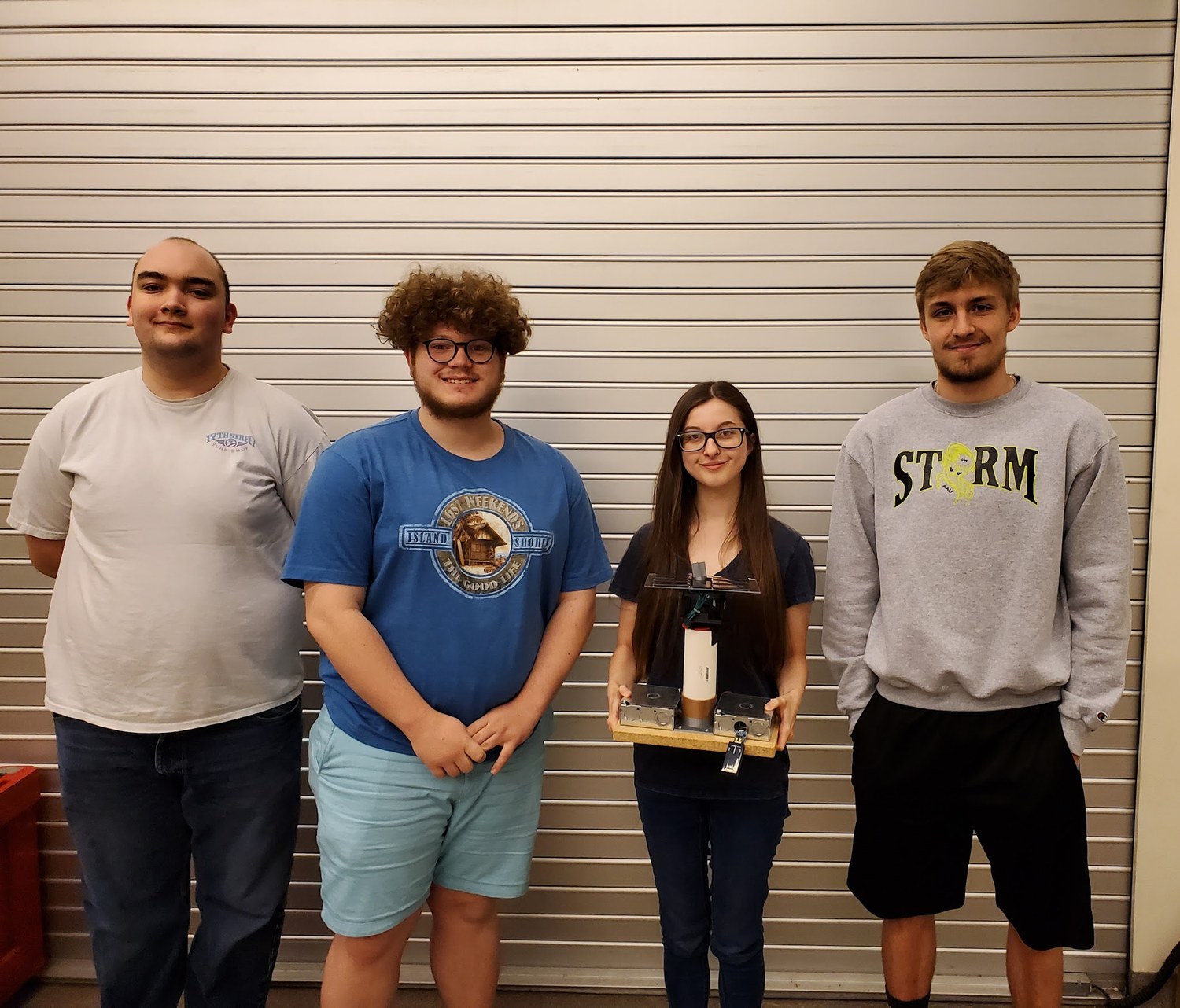 The four-person G.A.S.E. team with the finished tracker